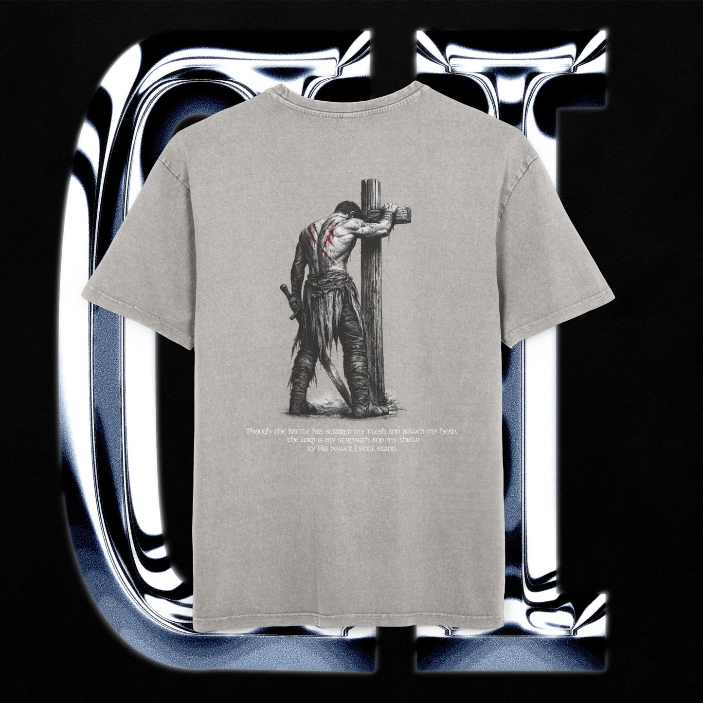 Gray t-shirt with a graphic design of a person on a cross and text, displayed against a reflective silver background.